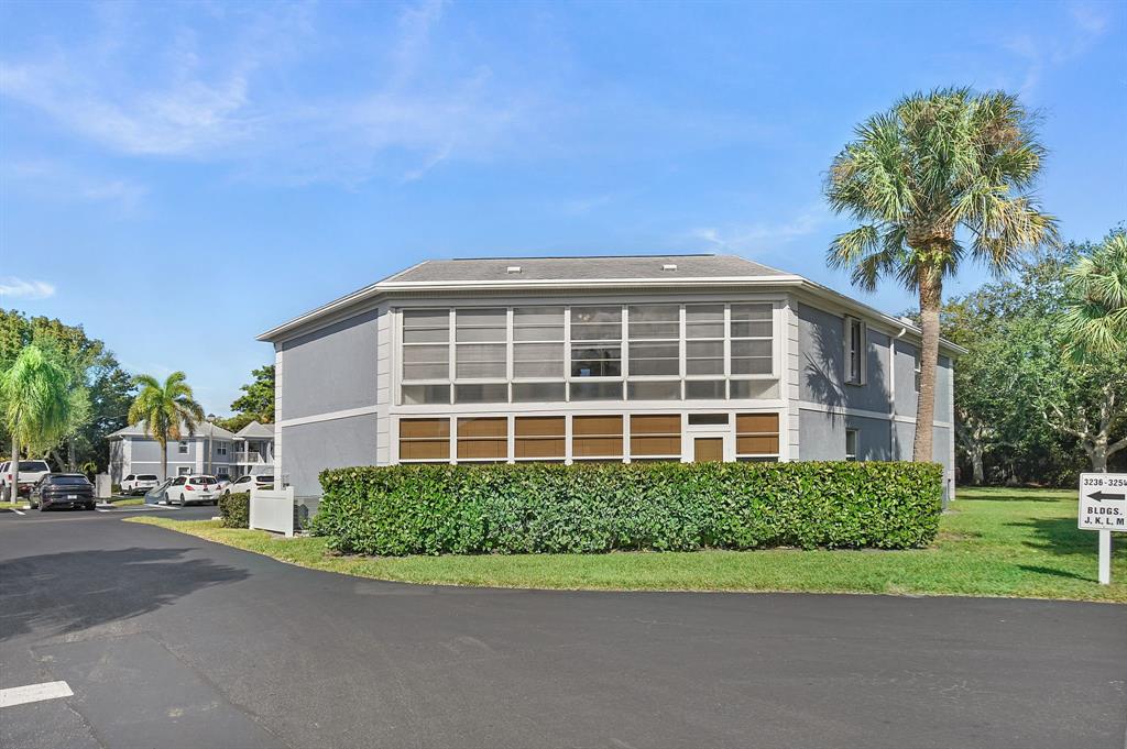 3254 Southeast Aster Lane, Unit J240 Stuart, FL 34994 - Photo 25 of 39 a view of a house with a yard