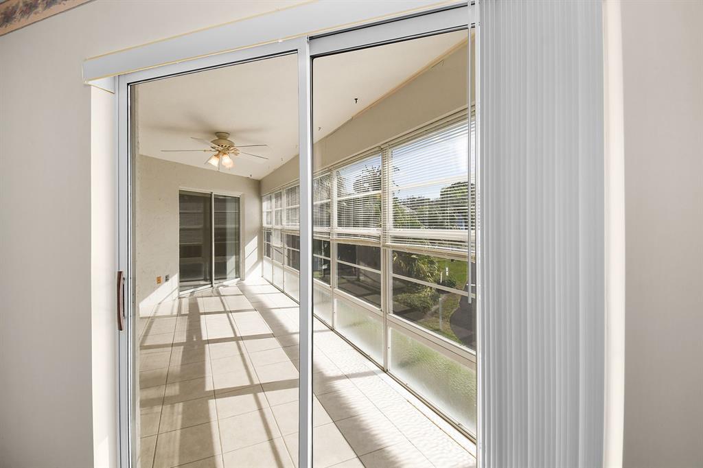 3254 Southeast Aster Lane, Unit J240 Stuart, FL 34994 - Photo 10 of 39 a view of a glass door with a glass door