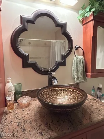 a kitchen with stainless steel appliances granite countertop a sink refrigerator and cabinets