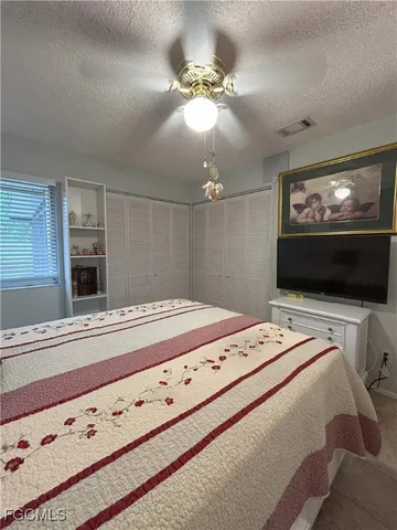 a bedroom with bed and a flat screen tv
