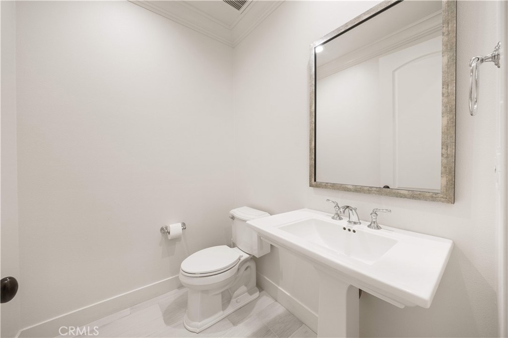 92 Interstellar Irvine, CA 92618 - Photo 14 of 64 a bathroom with a toilet a sink and mirror
