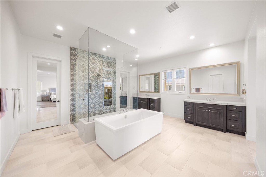 92 Interstellar Irvine, CA 92618 - Photo 30 of 64 a spacious bathroom with a tub sink shower and mirror