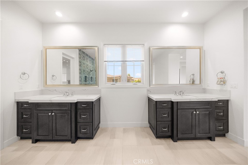 92 Interstellar Irvine, CA 92618 - Photo 32 of 64 a bathroom with a granite countertop sink and a large mirror