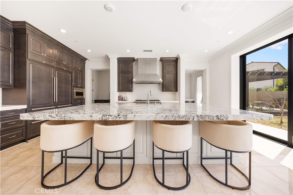 92 Interstellar Irvine, CA 92618 - Photo 5 of 64 a kitchen with a table chairs stove and cabinets
