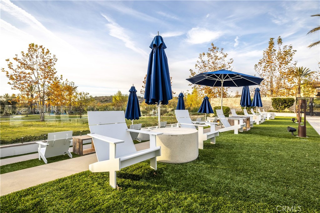 92 Interstellar Irvine, CA 92618 - Photo 52 of 64 a view of a patio with table and chairs potted plants and large tree