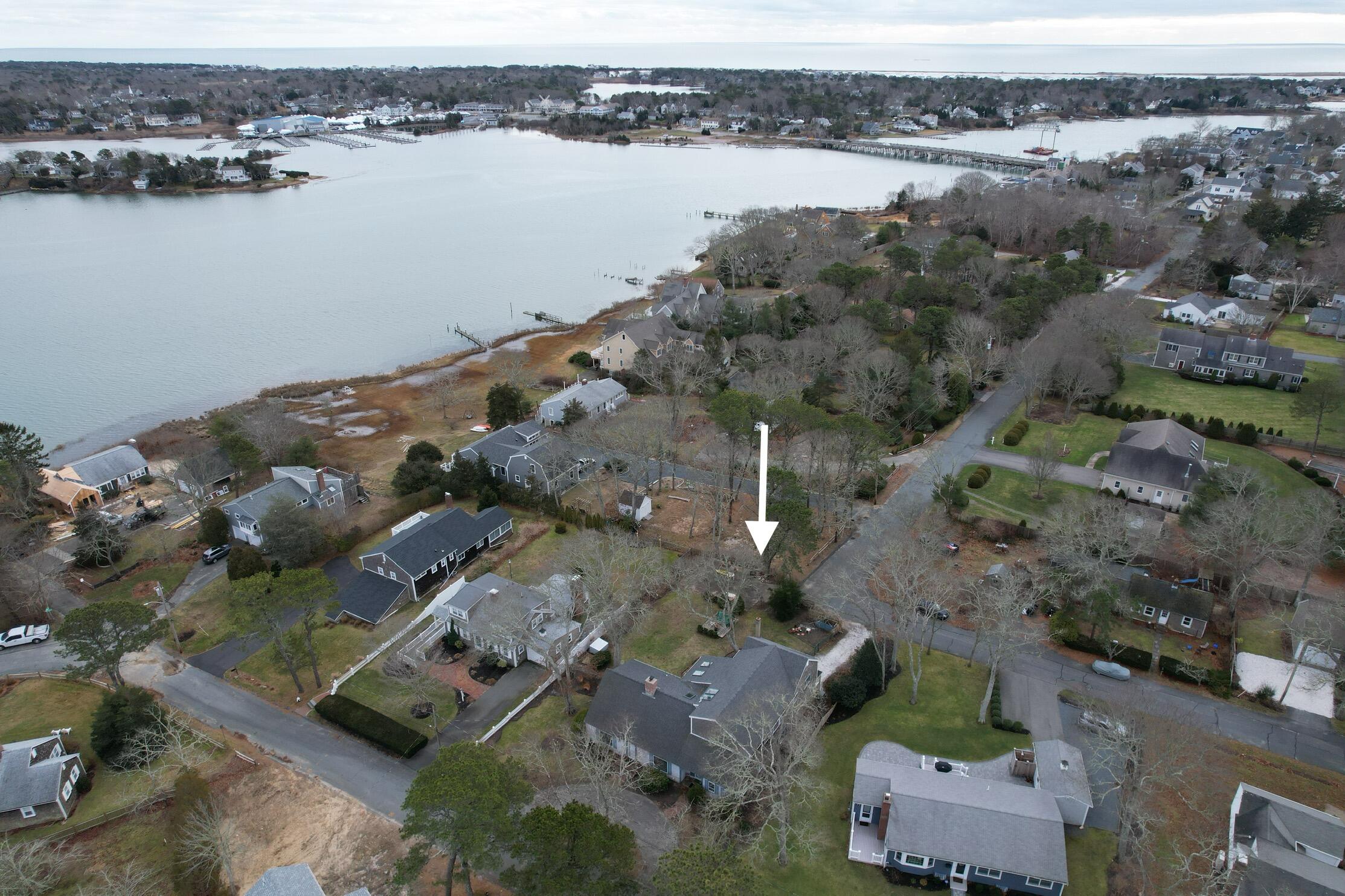 an aerial view of house with yard and ocean view