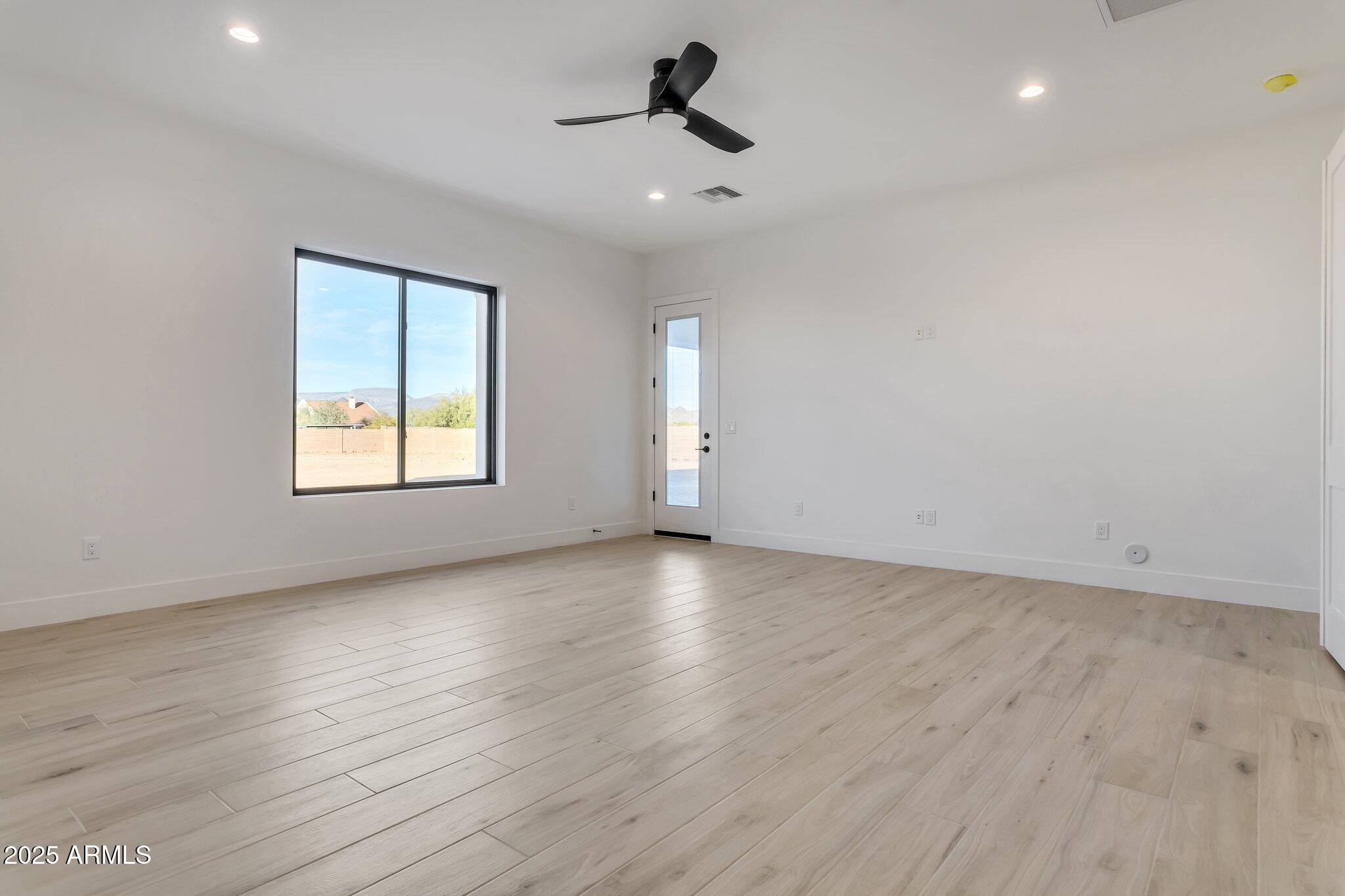 1602 East Cloud Road Phoenix, AZ 85086 - Photo 20 of 45 an empty room with wooden floor and windows