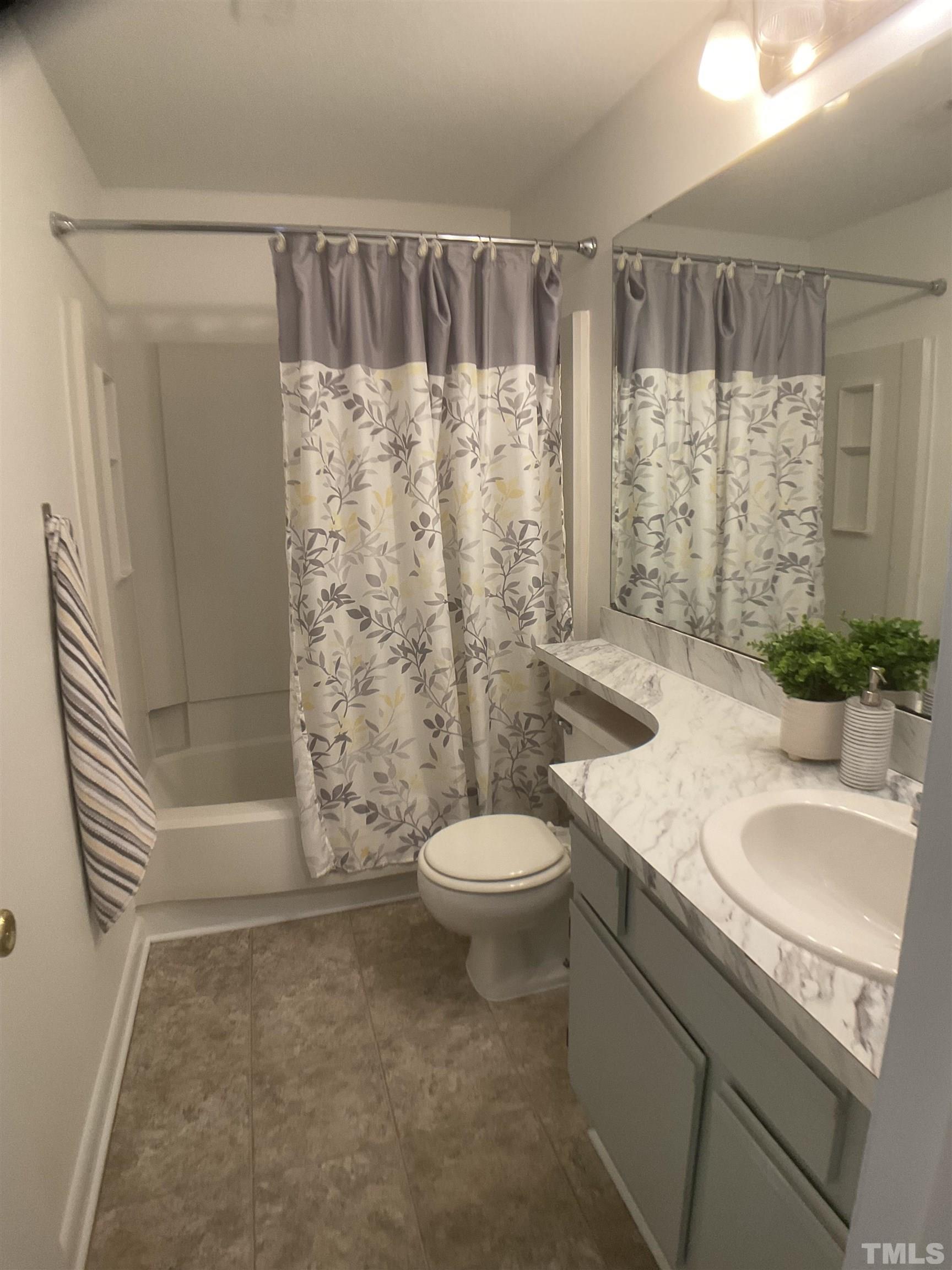 5812 Pointer Drive, Unit 202 Raleigh, NC 27609 - Photo 11 of 19 a bathroom with a granite countertop sink toilet and shower