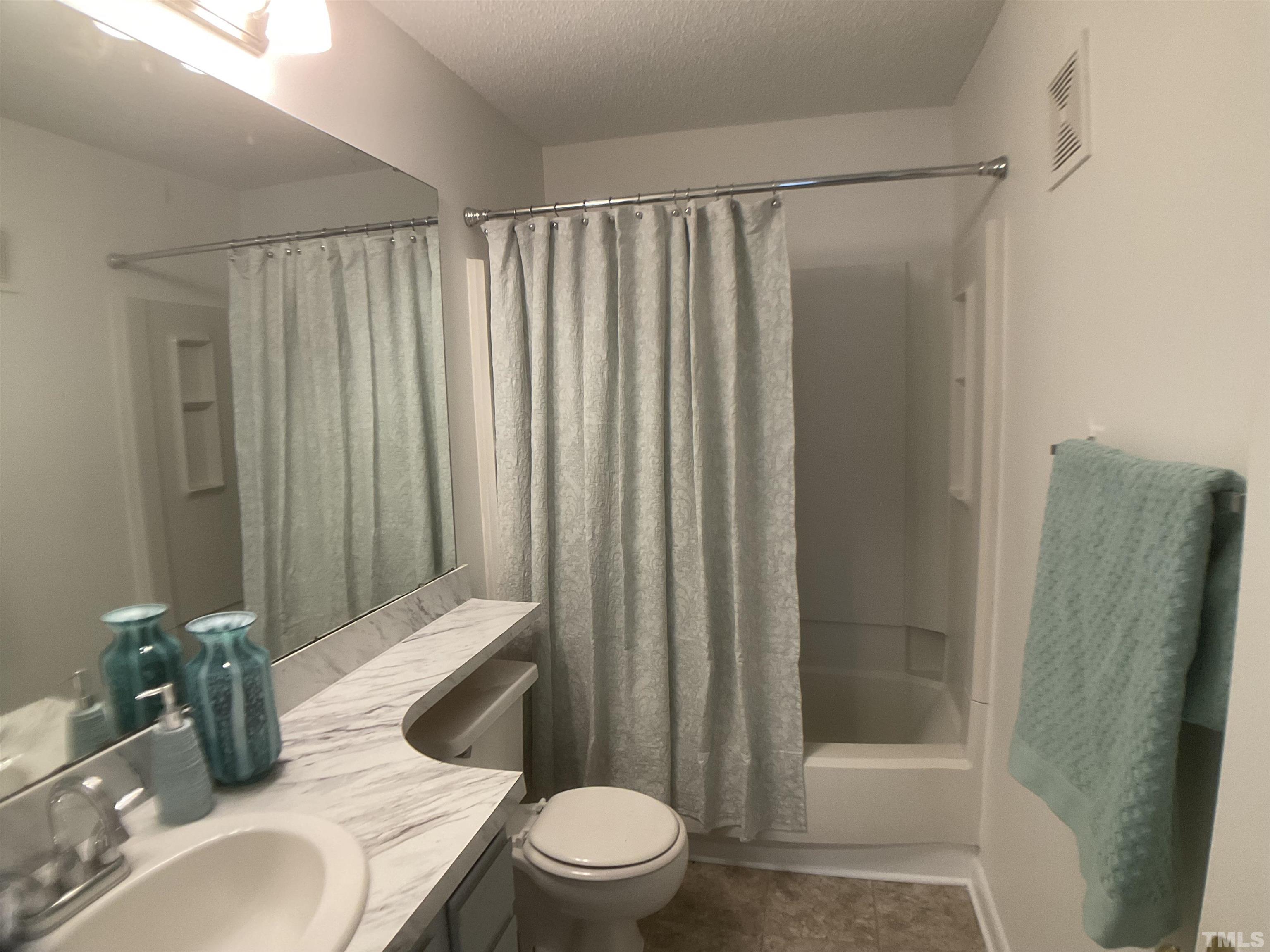 5812 Pointer Drive, Unit 202 Raleigh, NC 27609 - Photo 13 of 19 a bathroom with a toilet a sink and shower
