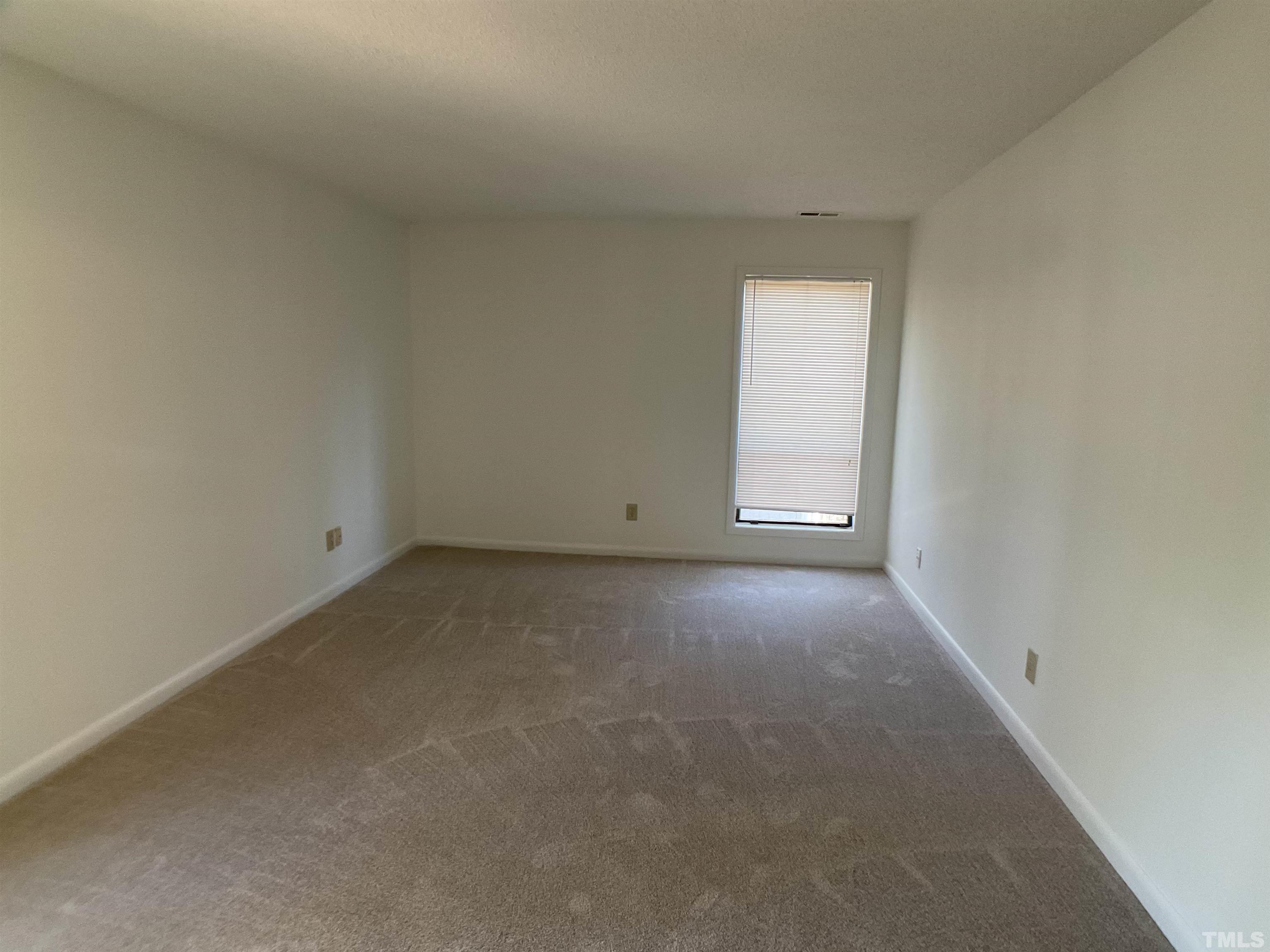 5812 Pointer Drive, Unit 202 Raleigh, NC 27609 - Photo 14 of 19 a view of an empty room with a window