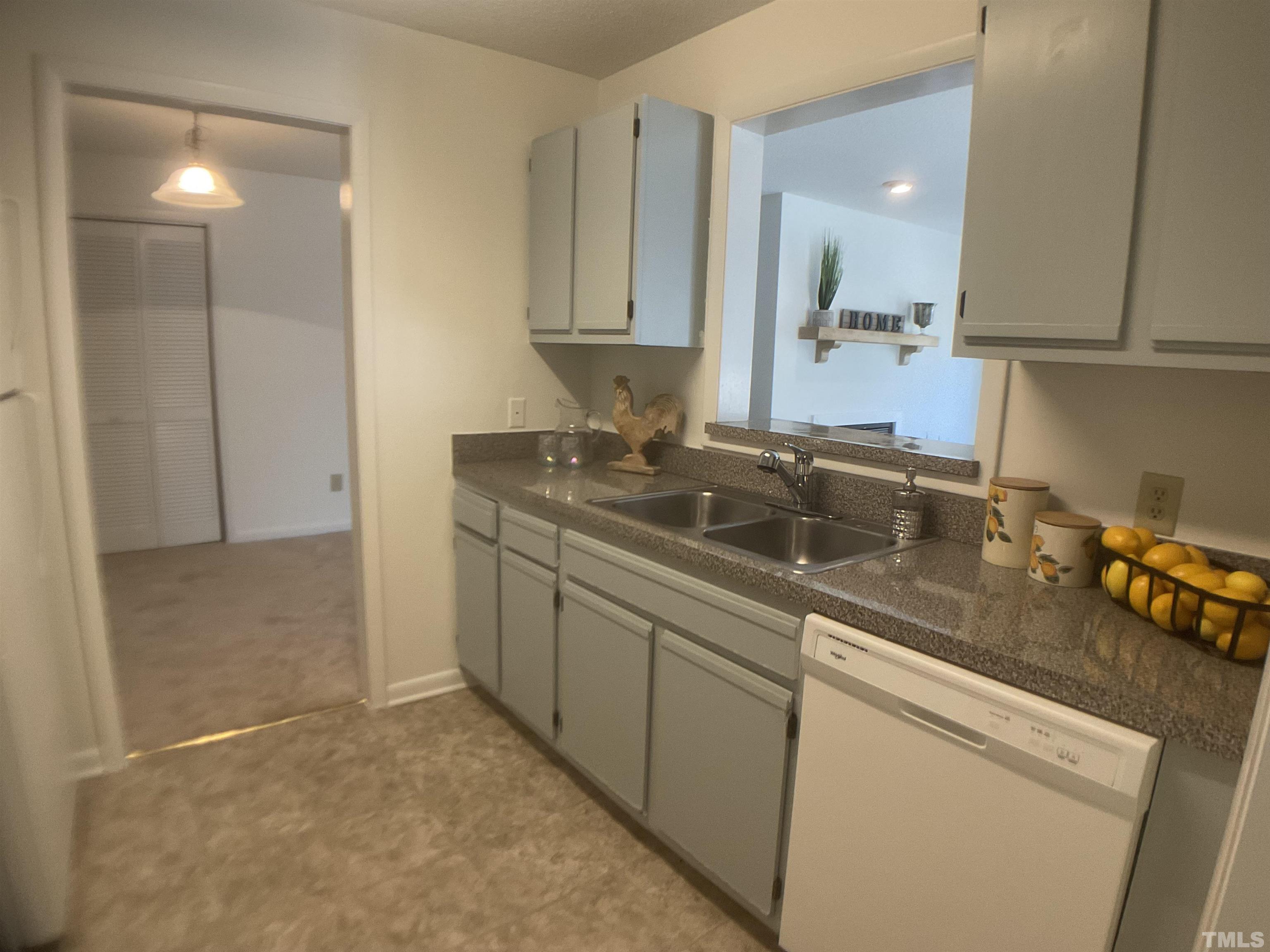 5812 Pointer Drive, Unit 202 Raleigh, NC 27609 - Photo 4 of 19 a kitchen with stainless steel appliances granite countertop a sink stove and cabinets