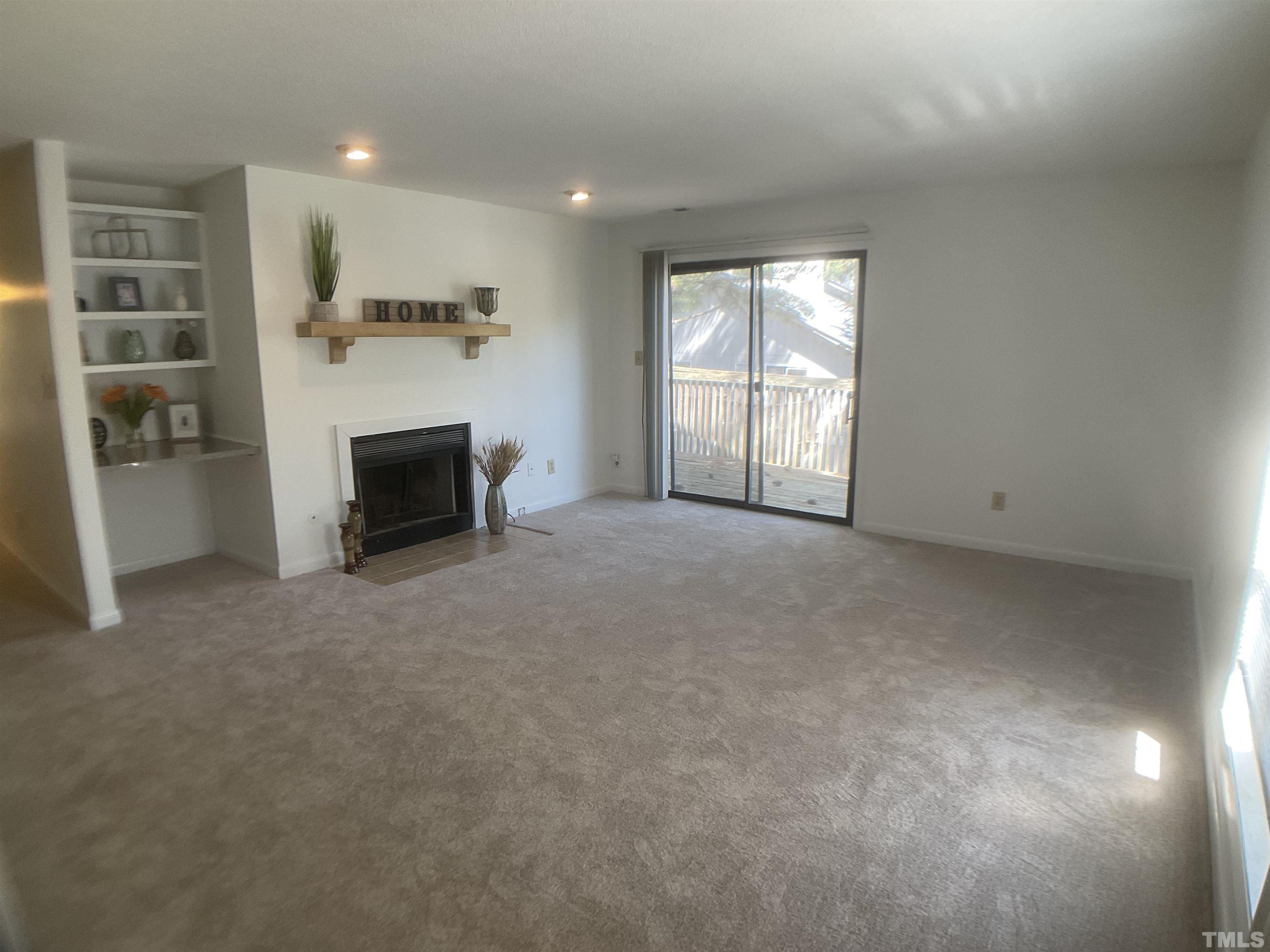 5812 Pointer Drive, Unit 202 Raleigh, NC 27609 - Photo 5 of 19 an empty room with fireplace and windows