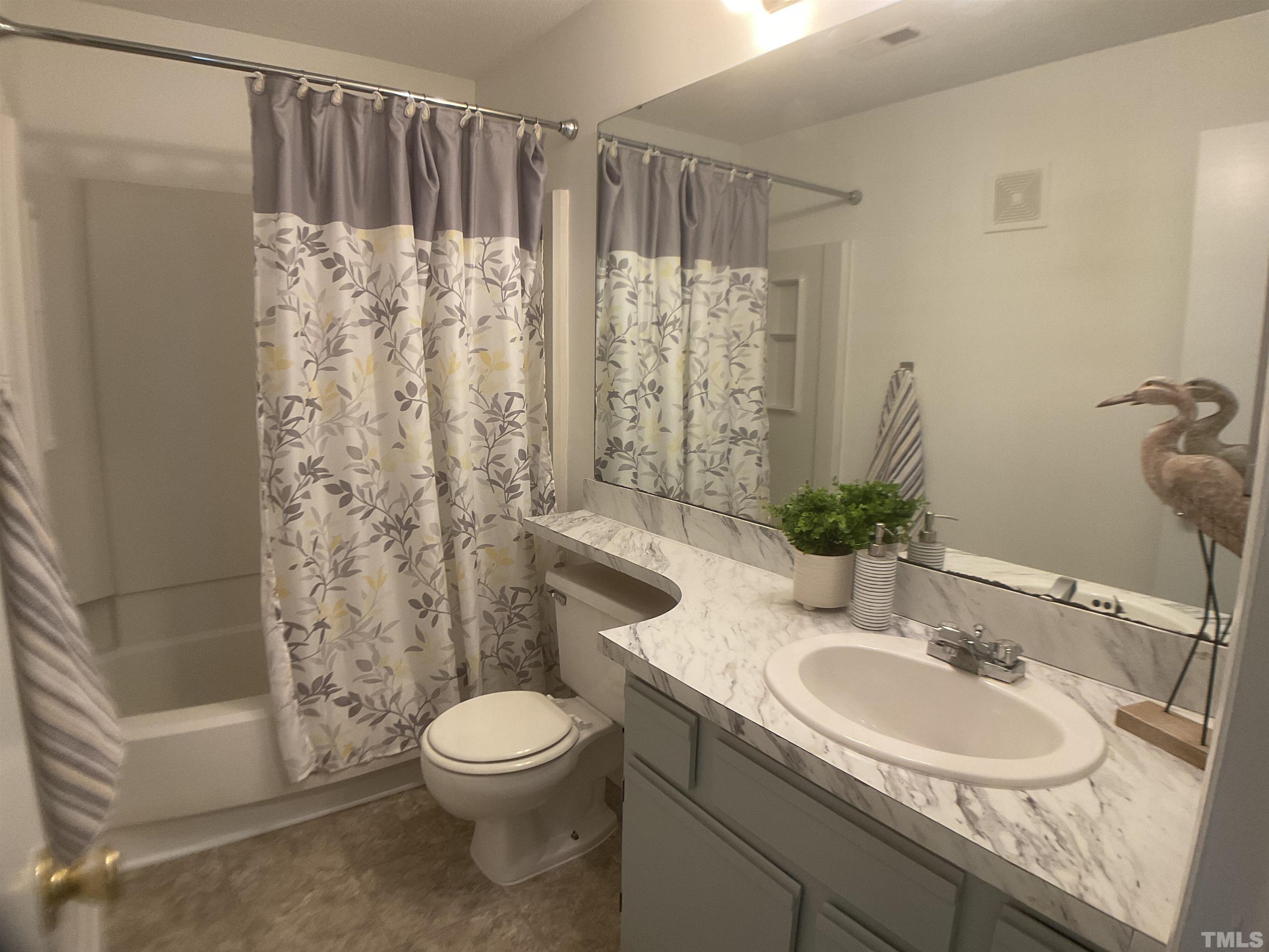 5812 Pointer Drive, Unit 202 Raleigh, NC 27609 - Photo 10 of 19 a bathroom with a sink toilet and shower