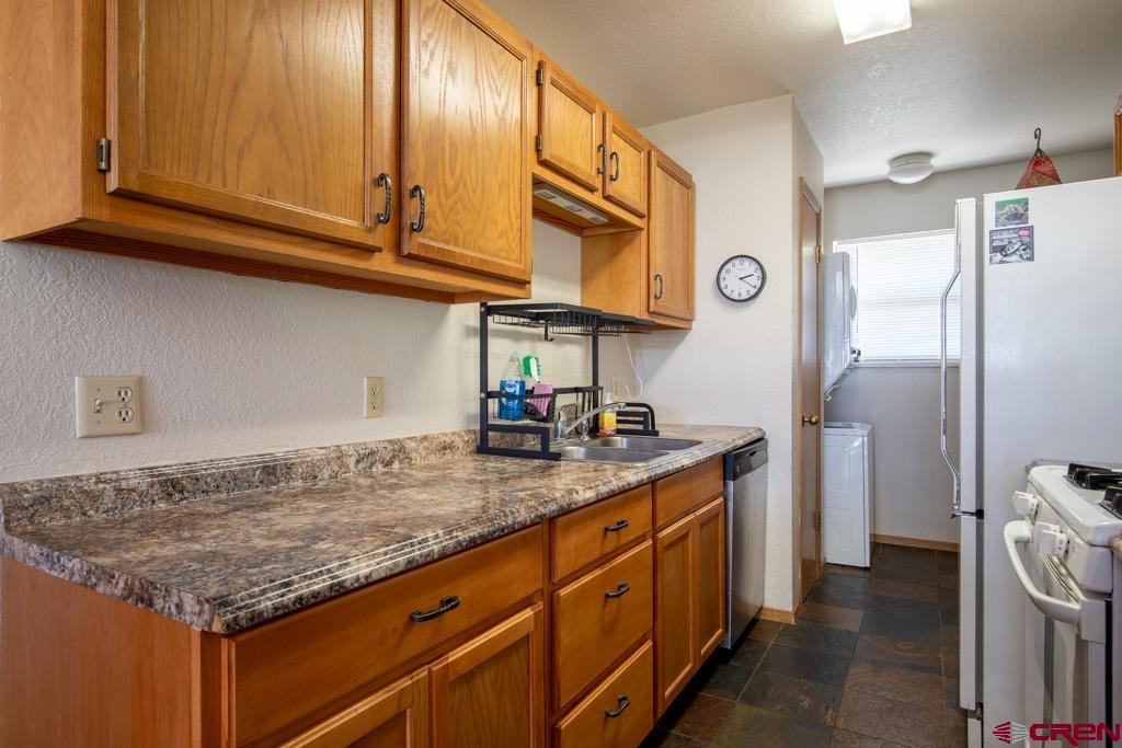 128 Hermosa Circle Durango, CO 81301 - Photo 13 of 26 a kitchen with stainless steel appliances granite countertop a sink stove and refrigerator