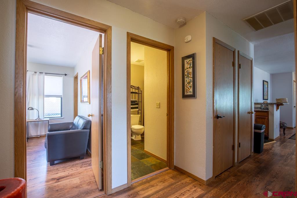 128 Hermosa Circle Durango, CO 81301 - Photo 21 of 26 a view of a hallway with wooden floor windows and a livingroom