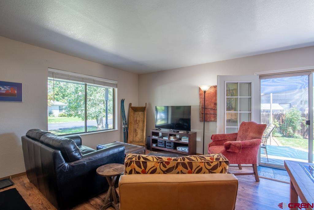 128 Hermosa Circle Durango, CO 81301 - Photo 8 of 26 a living room with furniture a large window and a flat screen tv