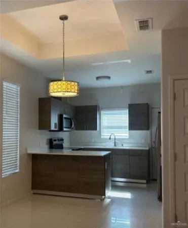 a kitchen with stainless steel appliances granite countertop a sink and a stove
