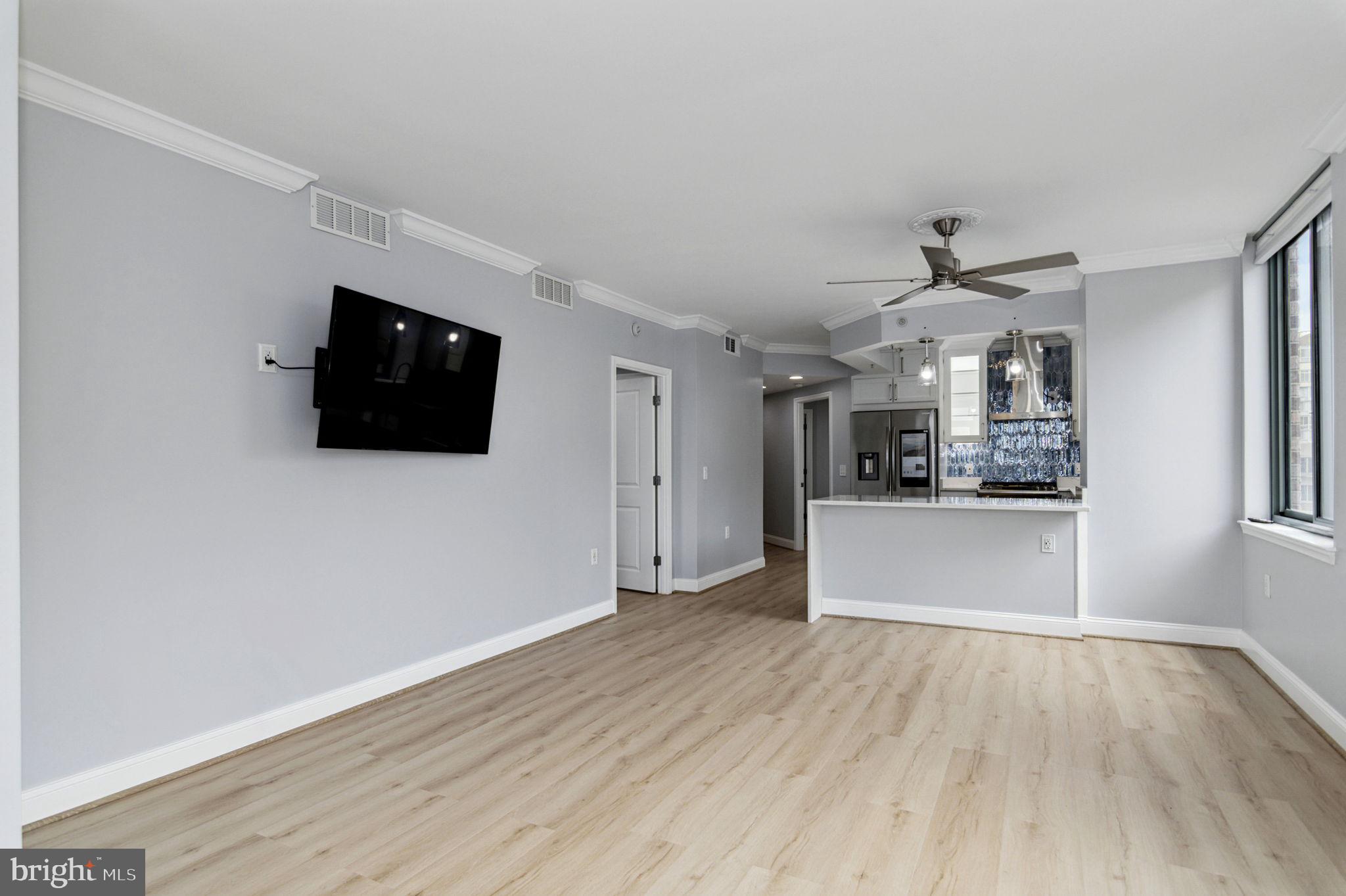 851 North Glebe Road, Unit 1404 Arlington, VA 22203 - Photo 13 of 62 a view of a kitchen with wooden floor and electronic appliances