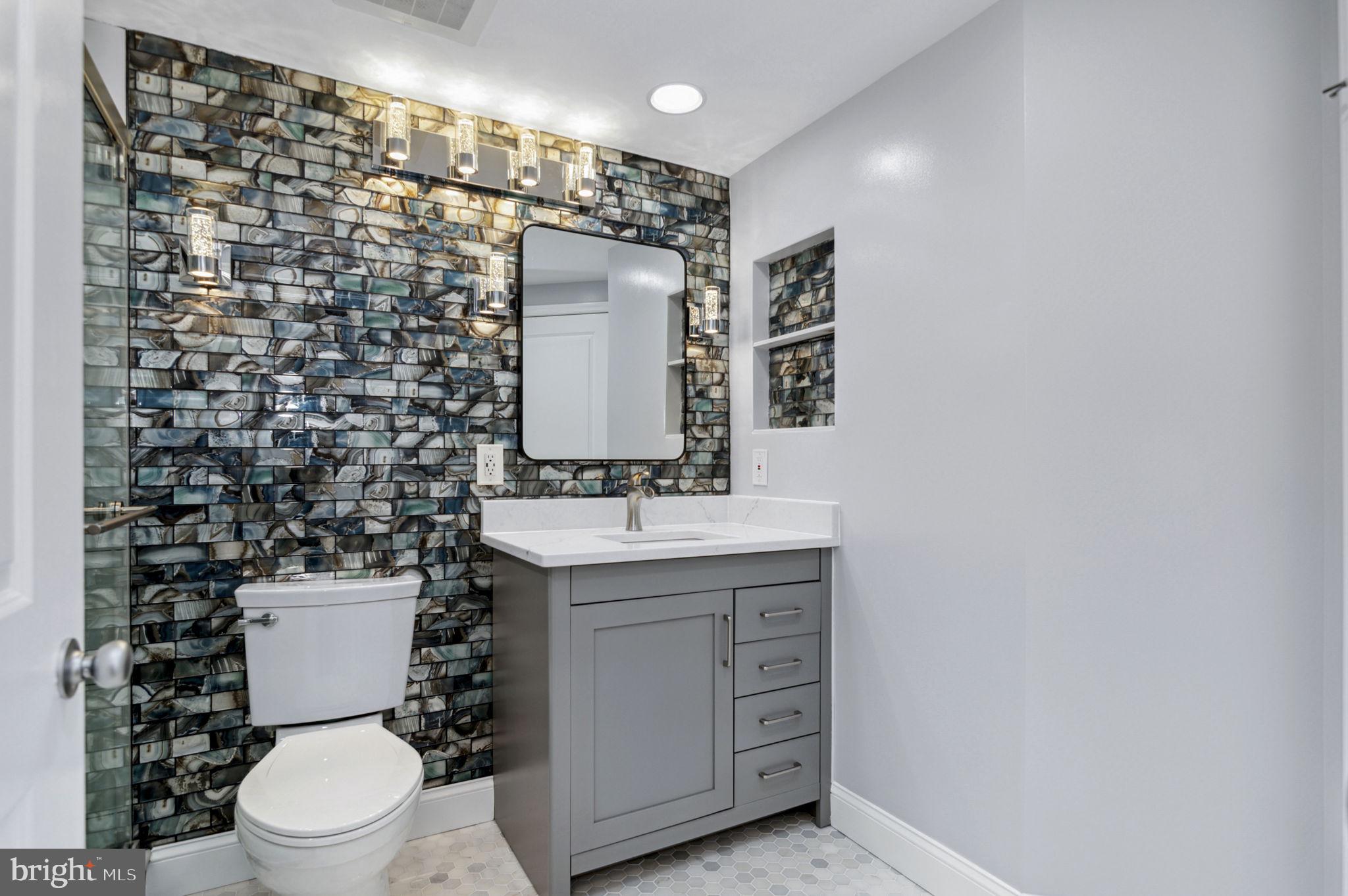 851 North Glebe Road, Unit 1404 Arlington, VA 22203 - Photo 23 of 62 a bathroom with a sink toilet vanity and shower