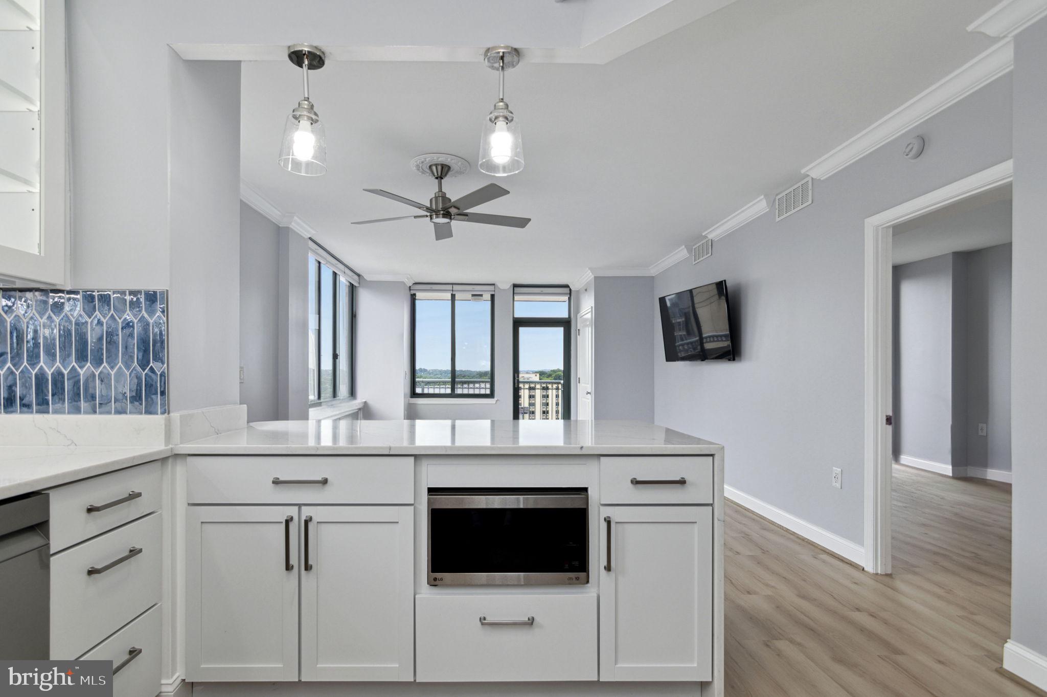 851 North Glebe Road, Unit 1404 Arlington, VA 22203 - Photo 6 of 62 a kitchen with white cabinets and white appliances