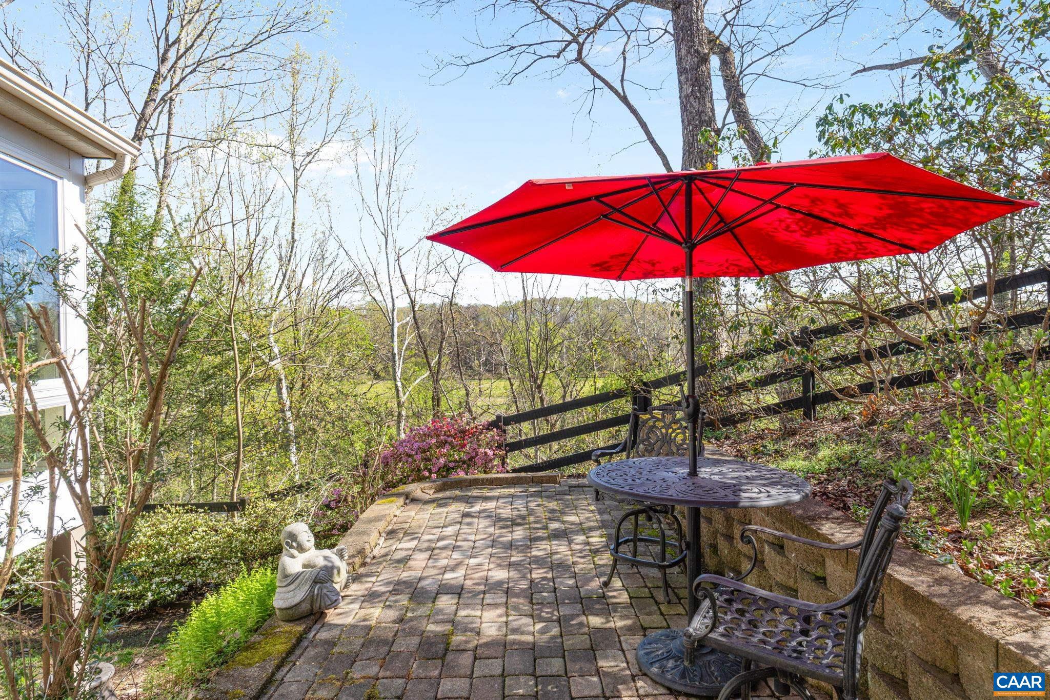 10 Mechunk Terrace Palmyra, VA 22963 - Photo 18 of 62 a view of a patio with a table and chairs under an umbrella