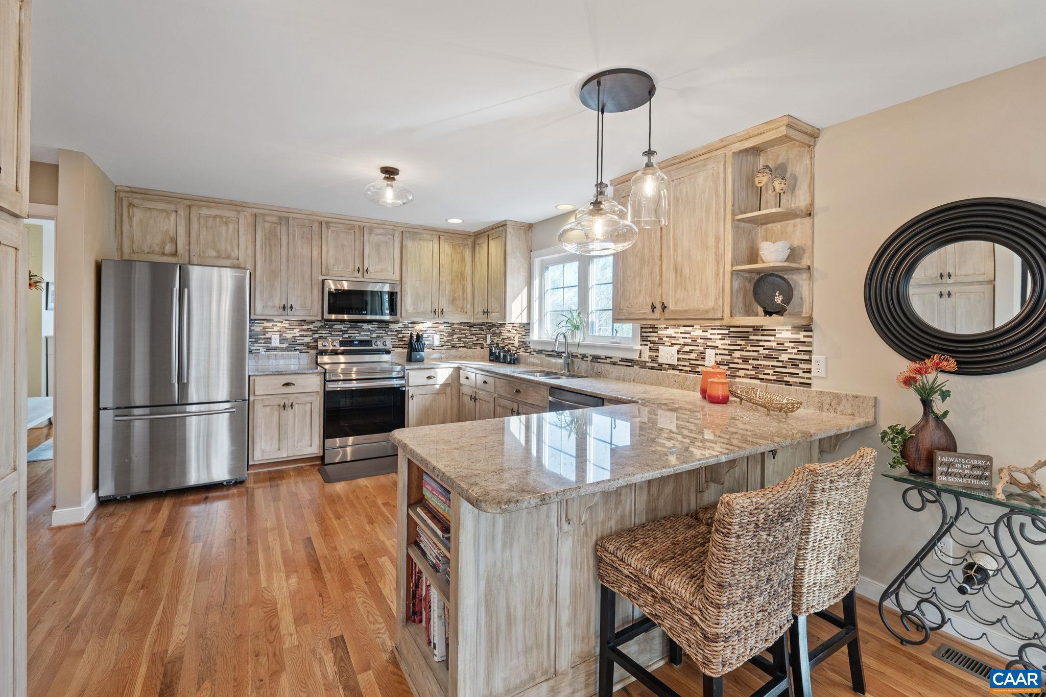10 Mechunk Terrace Palmyra, VA 22963 - Photo 20 of 62 a kitchen with stainless steel appliances granite countertop a sink a stove and a refrigerator