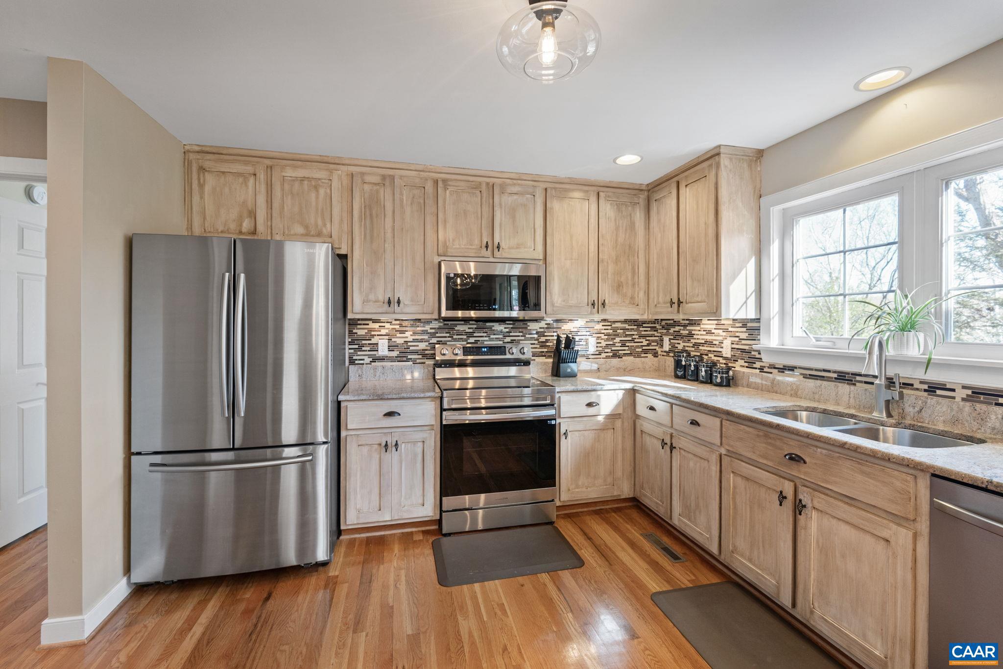 10 Mechunk Terrace Palmyra, VA 22963 - Photo 26 of 62 a kitchen with a refrigerator sink and wooden floor