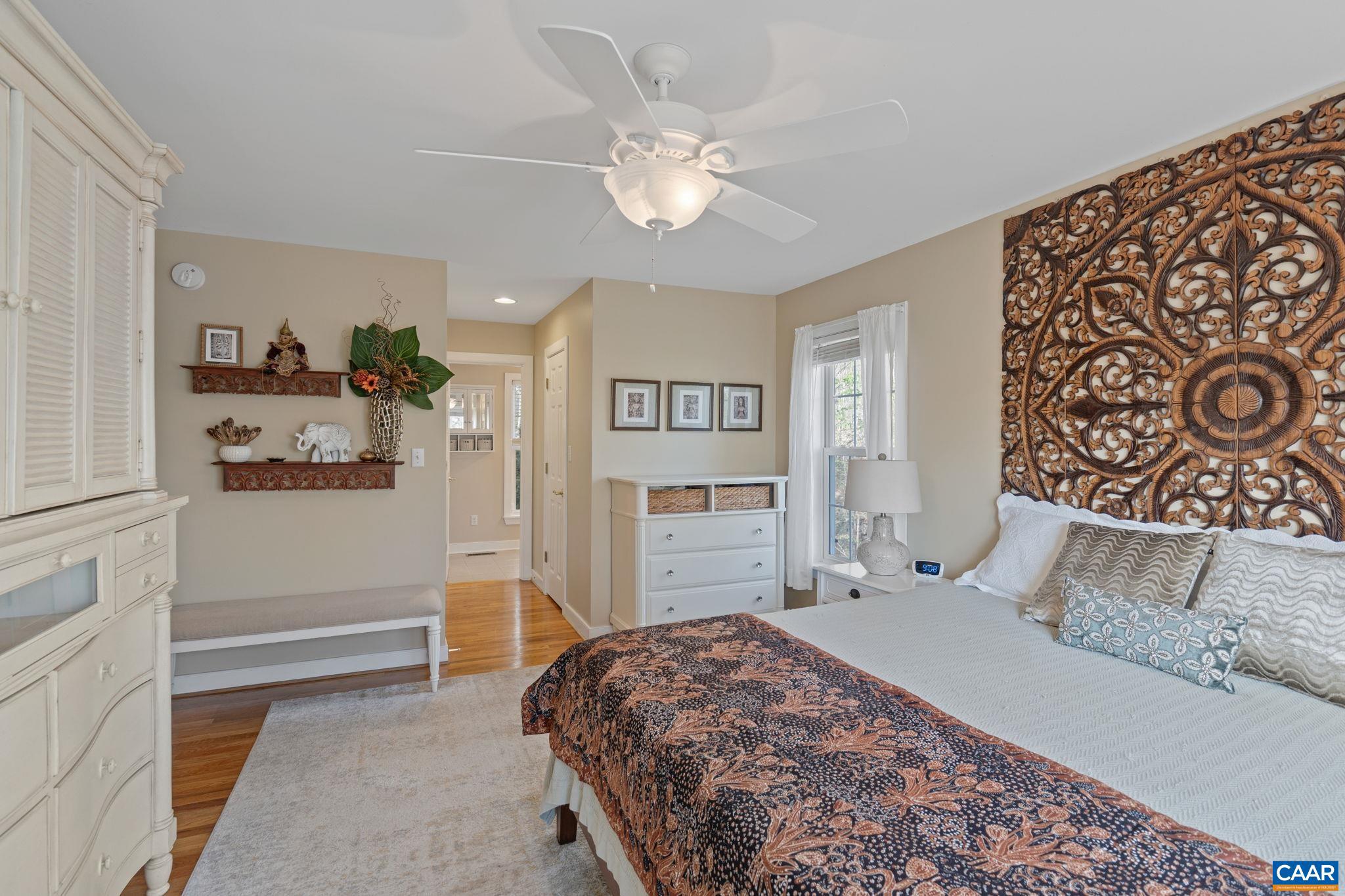 10 Mechunk Terrace Palmyra, VA 22963 - Photo 28 of 62 a bedroom with a large bed and a chandelier