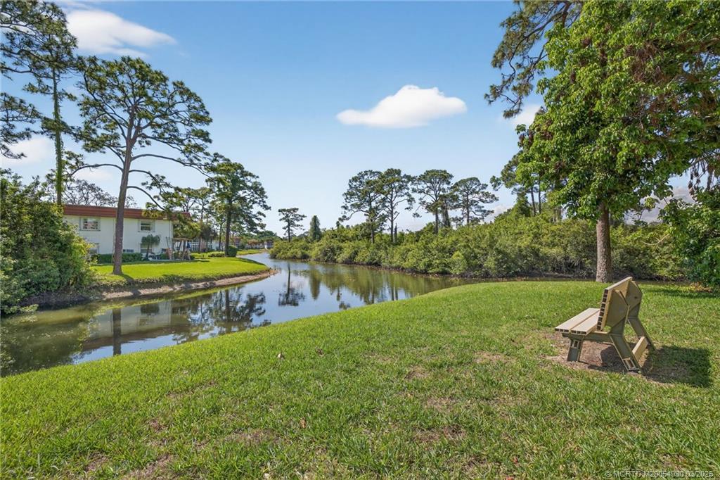 1225 Northwest 21st Street, Unit 1810 Stuart, FL 34994 - Photo 1 of 48 a view of a swimming pool with a yard