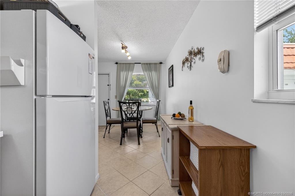 1225 Northwest 21st Street, Unit 1810 Stuart, FL 34994 - Photo 11 of 48 a view of kitchen with furniture and a window