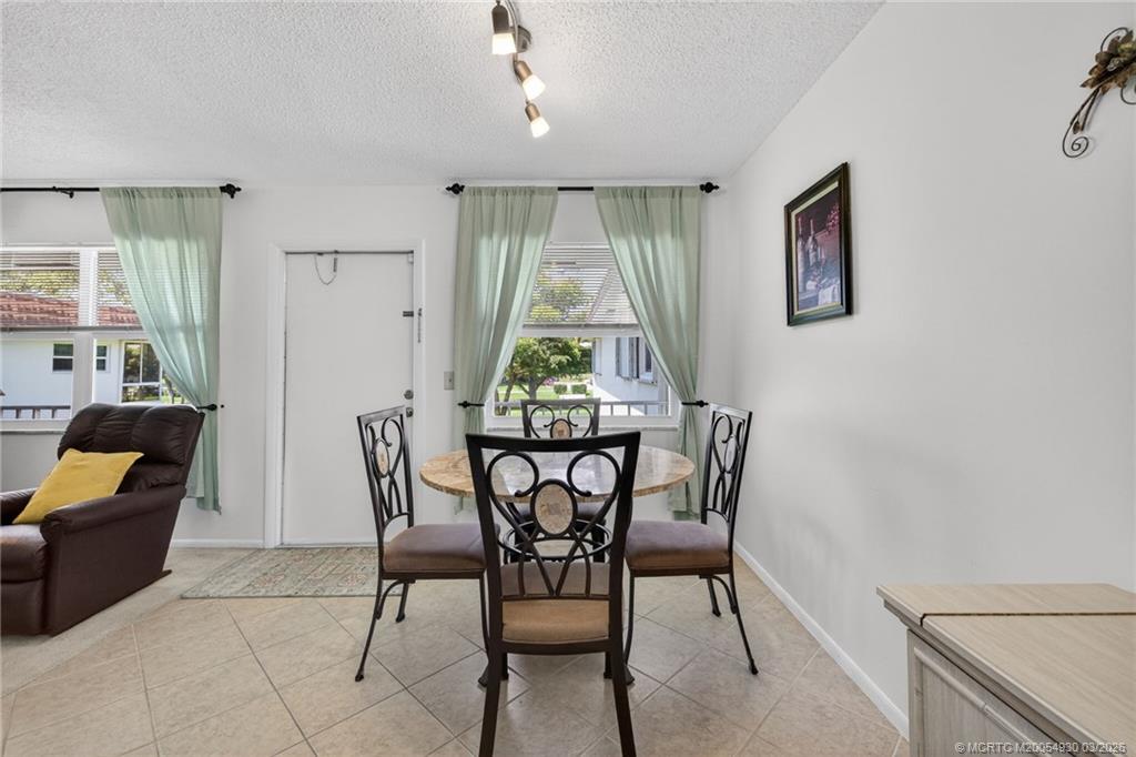 1225 Northwest 21st Street, Unit 1810 Stuart, FL 34994 - Photo 12 of 48 a view of a dining room with furniture window and outside view