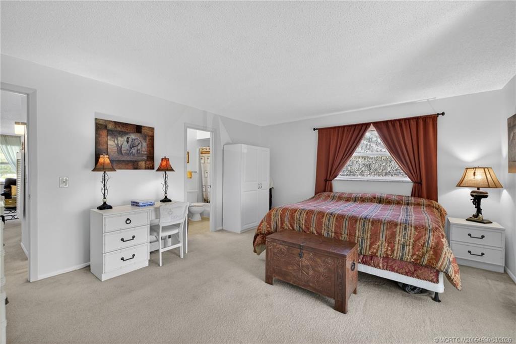 1225 Northwest 21st Street, Unit 1810 Stuart, FL 34994 - Photo 14 of 48 a bedroom with a bed and a window
