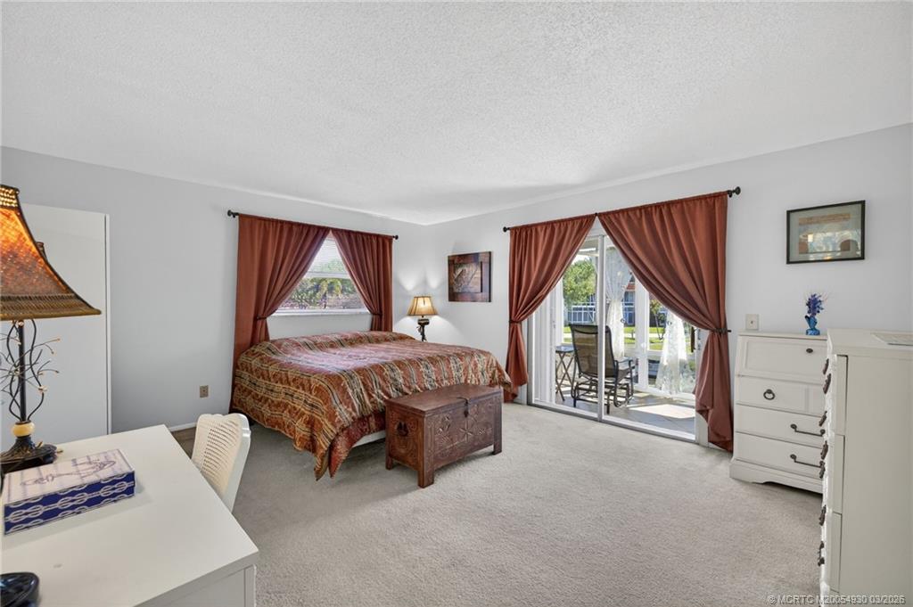 1225 Northwest 21st Street, Unit 1810 Stuart, FL 34994 - Photo 15 of 48 a bed room with a bed and a window