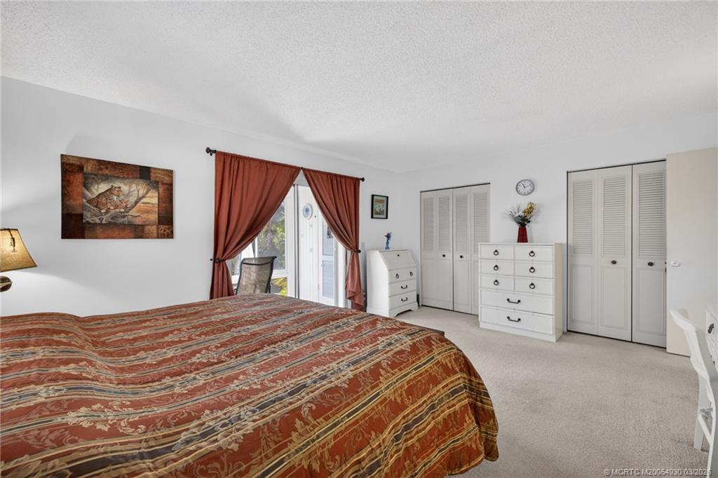 1225 Northwest 21st Street, Unit 1810 Stuart, FL 34994 - Photo 18 of 48 a bedroom with a large bed and a window