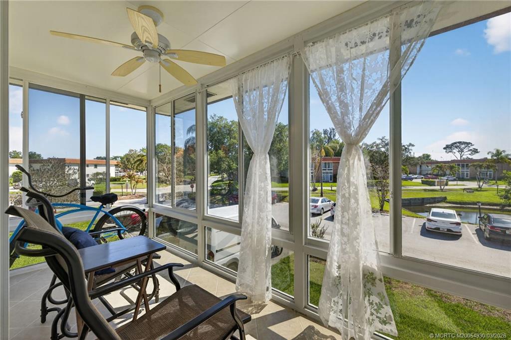 1225 Northwest 21st Street, Unit 1810 Stuart, FL 34994 - Photo 20 of 48 a living room with large windows