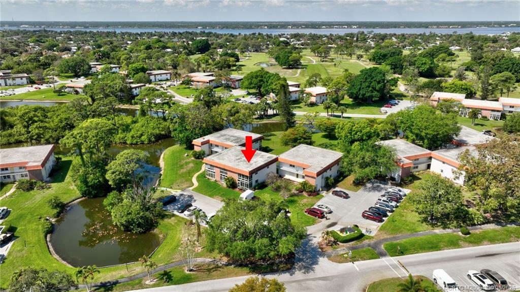 1225 Northwest 21st Street, Unit 1810 Stuart, FL 34994 - Photo 30 of 48 an aerial view of residential house with outdoor space and swimming pool