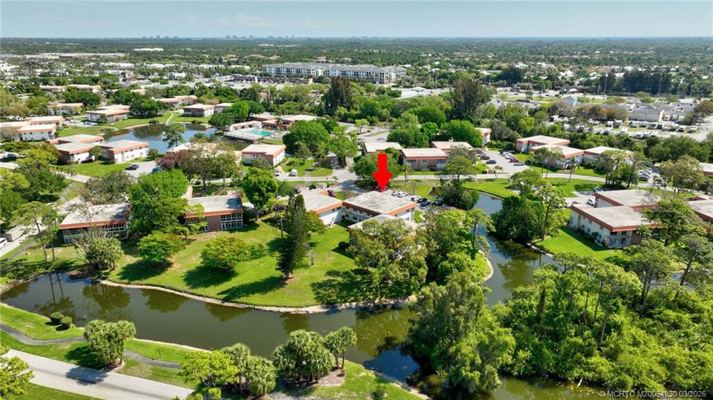 1225 Northwest 21st Street, Unit 1810 Stuart, FL 34994 - Photo 31 of 48 an aerial view of residential houses with outdoor space and trees