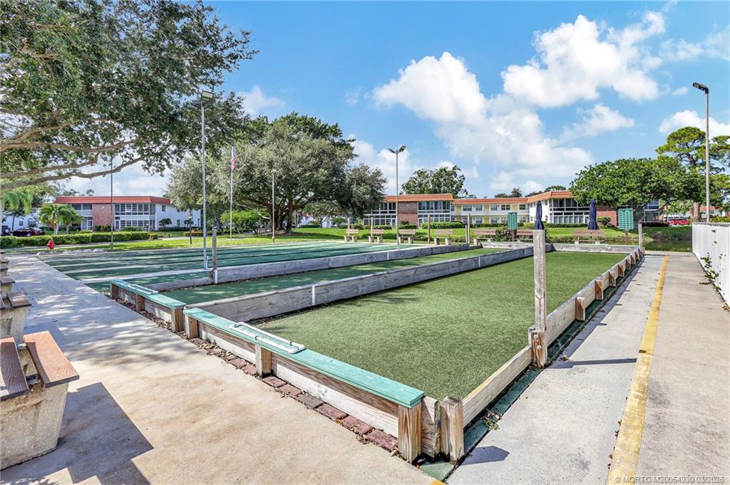 1225 Northwest 21st Street, Unit 1810 Stuart, FL 34994 - Photo 37 of 48 a view of a swimming pool and a yard