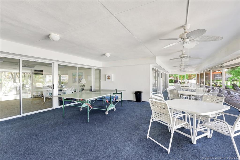 1225 Northwest 21st Street, Unit 1810 Stuart, FL 34994 - Photo 38 of 48 a view of a dining room with furniture window and outside view