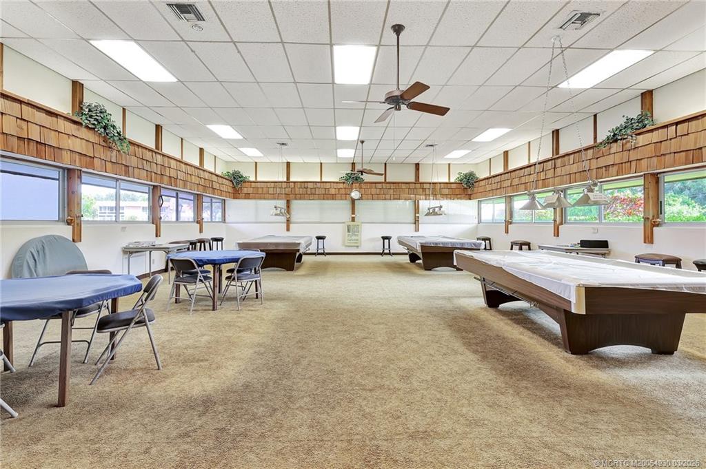 1225 Northwest 21st Street, Unit 1810 Stuart, FL 34994 - Photo 39 of 48 a large hall with dining table and chairs
