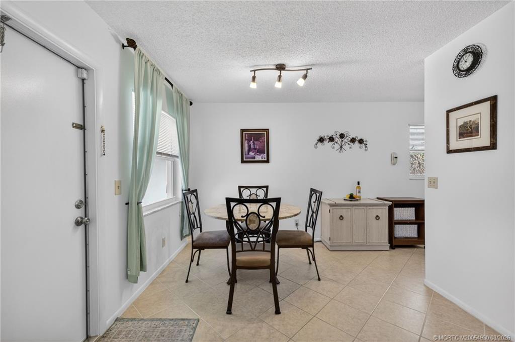 1225 Northwest 21st Street, Unit 1810 Stuart, FL 34994 - Photo 5 of 48 a view of a dining room with furniture