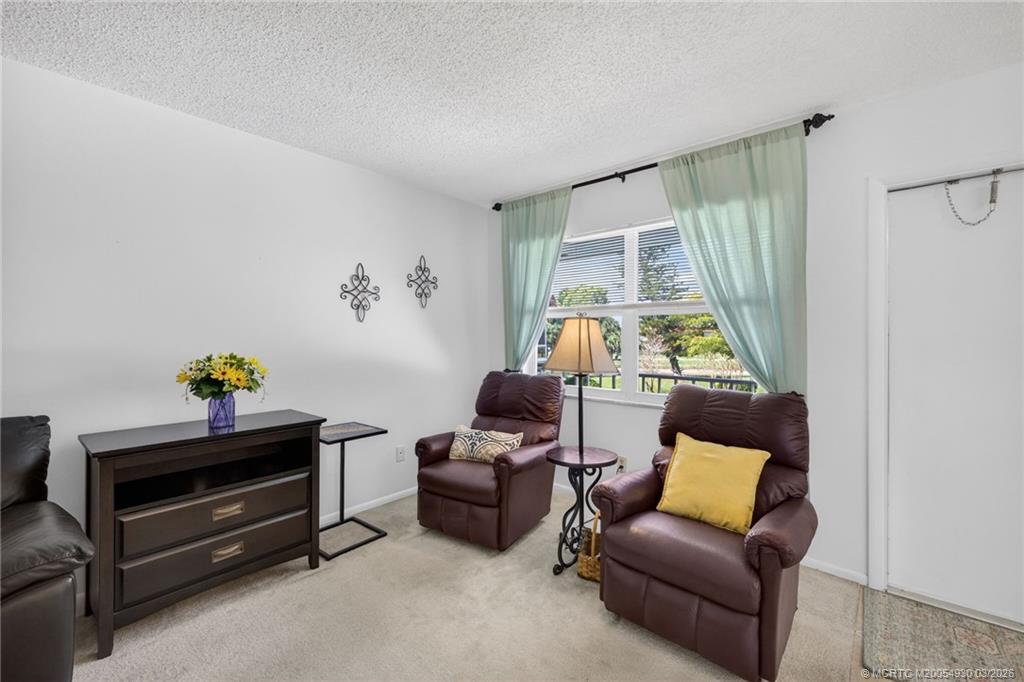 1225 Northwest 21st Street, Unit 1810 Stuart, FL 34994 - Photo 7 of 48 a bedroom with furniture and a window