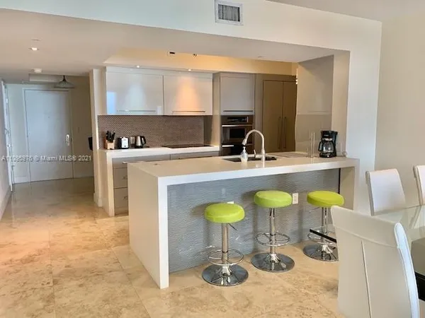 a kitchen with a sink cabinets and wooden floor