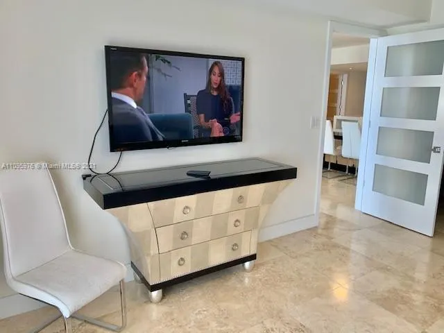 a living room with furniture and a wall painting