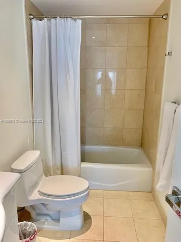 a bathroom with a sink toilet and mirror