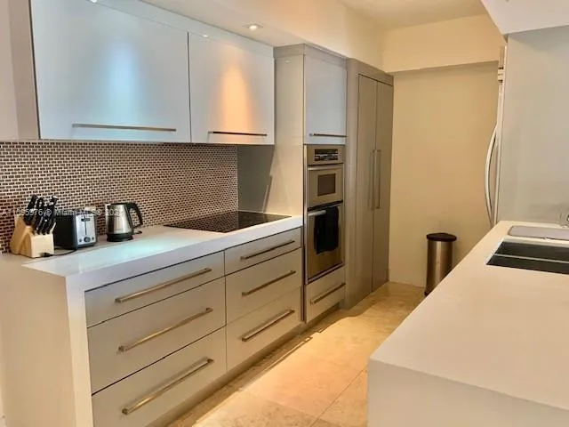 a kitchen with stainless steel appliances a refrigerator sink and cabinets