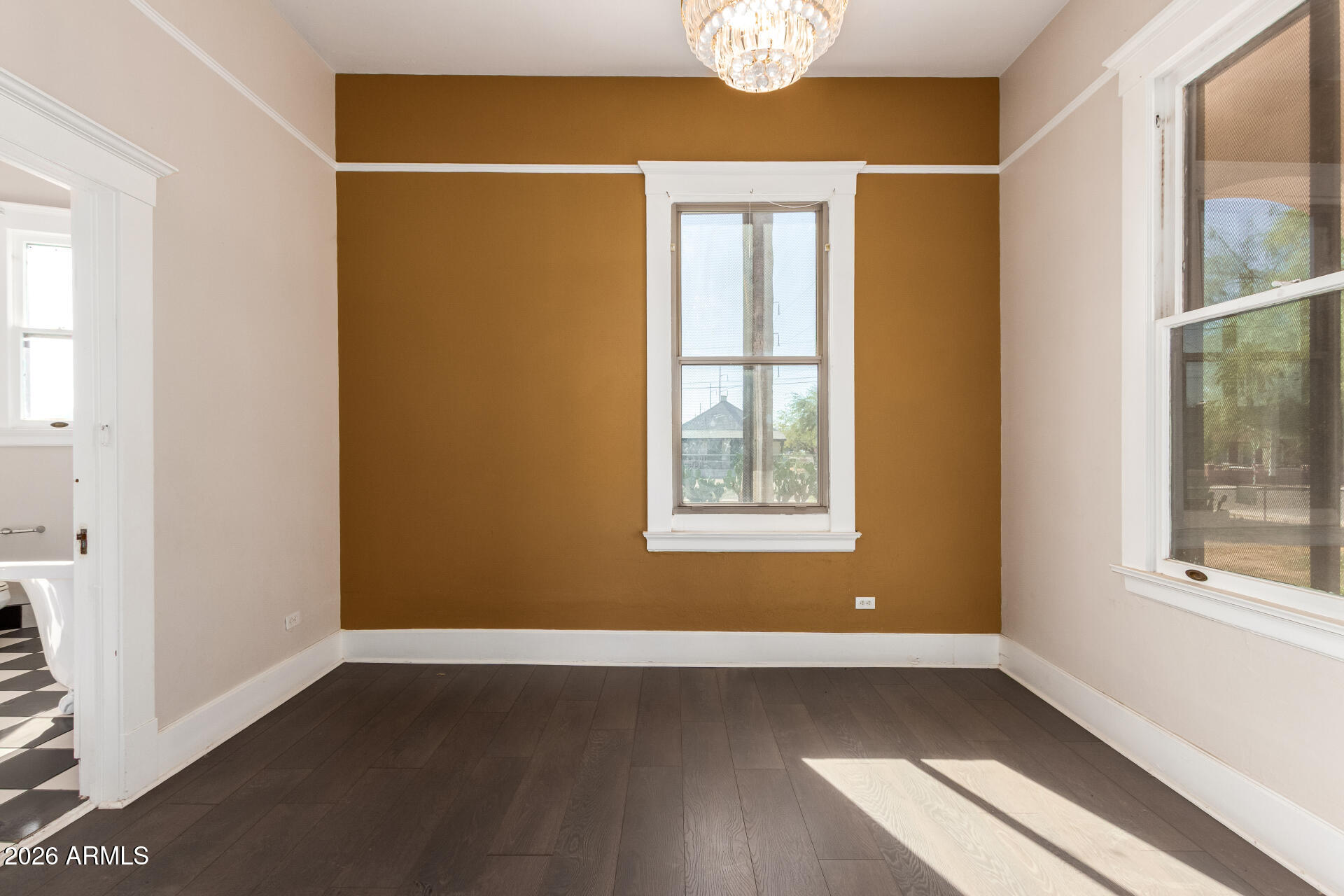 819 South 3rd Avenue Phoenix, AZ 85003 - Photo 17 of 45 an empty room with wooden floor and windows