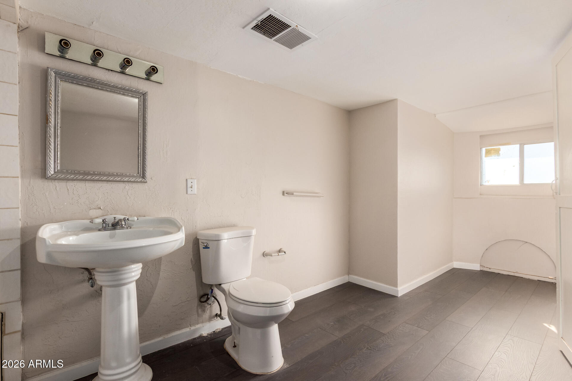 819 South 3rd Avenue Phoenix, AZ 85003 - Photo 26 of 45 a bathroom with a toilet sink and mirror