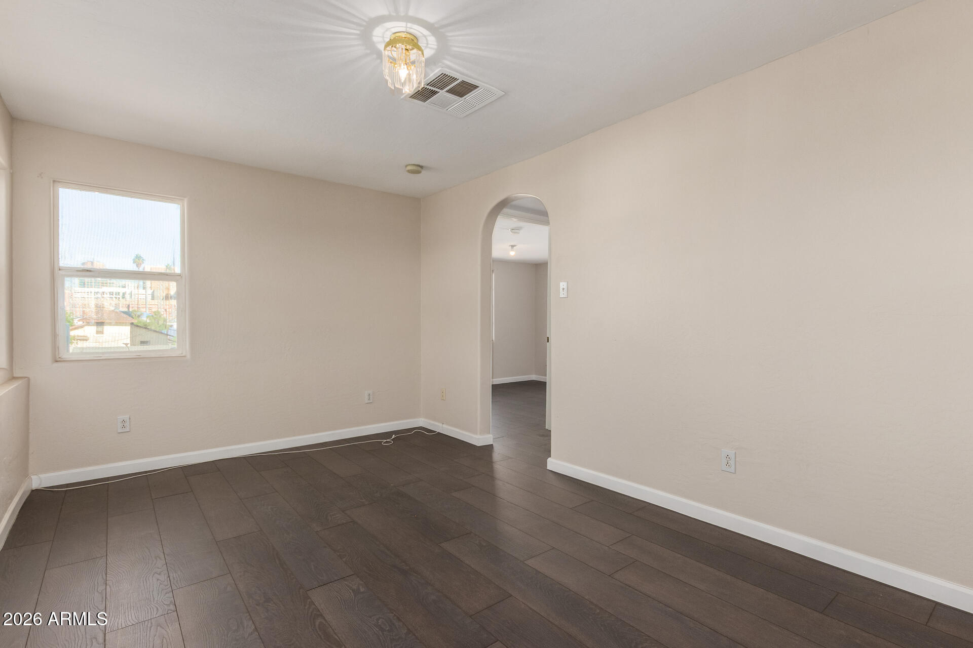 819 South 3rd Avenue Phoenix, AZ 85003 - Photo 29 of 45 an empty room with wooden floor and windows