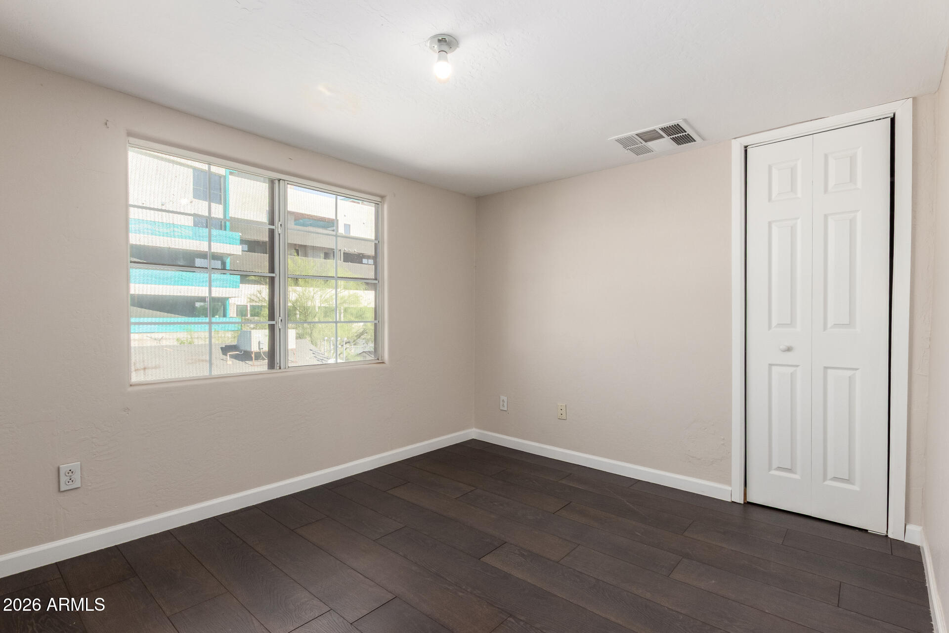 819 South 3rd Avenue Phoenix, AZ 85003 - Photo 30 of 45 an empty room with wooden floor and windows